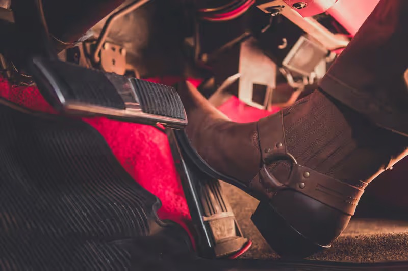 Why does my brake pedal feel soft or spongy when I try to stop?